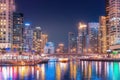 Night colorful view of the famous tourist attraction of the city of Dubai - Marina seaport and illuminated skyscrapers. Royalty Free Stock Photo