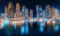 Night  view of the famous tourist attraction of the city of Dubai - Marina seaport and illuminated skyscrapers. Travel and Royalty Free Stock Photo