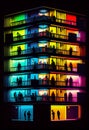 Night colorful windows lights of apartment building in city. AI generative Royalty Free Stock Photo