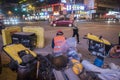 At night, a construction worker sitting at a road construction site Royalty Free Stock Photo