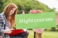 Night courses against pretty student studying outside on campus