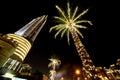 Night Dubai palms with decor lamps and skyscraper Royalty Free Stock Photo