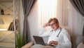 Night duty doctor man laptop couch evening window Royalty Free Stock Photo