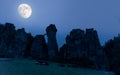 The impressive sandstone cliffs of the Externsteine during a full moon.