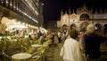 Night entertainment for tourists at illuminated St Marks square, tour to Venice