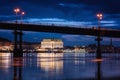 Night european city in colorful lights and reflection in water, Kiev, Ukraine. Pedestrian bridge across the Dnieper river Royalty Free Stock Photo