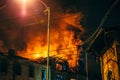 Night fire at roof in apartment building, burning house with huge smoke, Fire disaster and accident tragedy Royalty Free Stock Photo