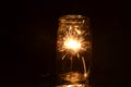 Night fireworks sparkler burning inside glass jar 1st version Royalty Free Stock Photo