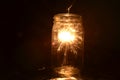 Night fireworks sparkler burning inside glass jar