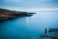 Night fishing near blurred ocean on the night