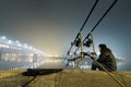 Night Fishing Urban Edition. Fisherman in Foggy night.