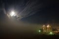 Night fog in moonlight and construction of a multi-storey building