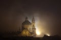 Night fog over Saint Nicholas Church in Prague, Czech Republic. Royalty Free Stock Photo