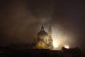Night Fog Over Saint Nicholas Church In Prague, Czech Republic.