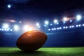 Night football arena in lights with a ball close up Royalty Free Stock Photo