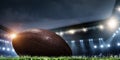 Night football arena in lights with a ball close up Royalty Free Stock Photo