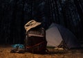 Night forest with backpack gear and clothing. Royalty Free Stock Photo
