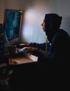 Night, hacker or man with computer, tech or typing with server or programmer with nerd or geek. Person, home or guy with Royalty Free Stock Photo