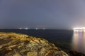 Night HDR long exposure photo of the shore of Malta, Saint Pauls Bay with ships on the horizon