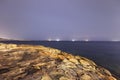 Night HDR long exposure photo of the shore of Malta, Saint Pauls Bay with ships on the horizon