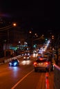 Night highway - cars drive along a narrow road. Headlights, cars, road, traffic