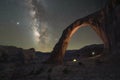 Night hiker standing under Corona Arch with the Milky Way Galaxy Royalty Free Stock Photo