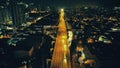 Night illuminated cityscape with traffic highway at business centre aerial. Twilight city neon light Royalty Free Stock Photo