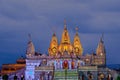 Night illuminated Shree Swaminarayan temple with dark blue cloud.