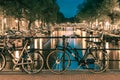 Night illumination of Amsterdam canal and bridge Royalty Free Stock Photo