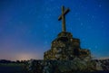 night image with stars visible in the sky with christian religious catholic crucifix on the right side