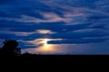 Night landscape with a bright moon in the cloudy sky