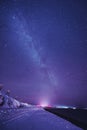 Night landscape with colorful Milky Way and yellow light at mountains. Starry sky with hills at summer. Beautiful Universe. Space Royalty Free Stock Photo