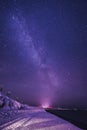 Night landscape with colorful Milky Way and yellow light at mountains. Starry sky with hills at summer. Beautiful Universe. Space Royalty Free Stock Photo