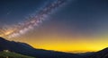 Night landscape with colorful Milky Way and yellow light at mountains. Starry sky with hills at summer. Beautiful Universe Royalty Free Stock Photo