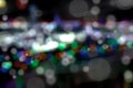 Bokeh - streaming white orbs of light against a luminous rainbow or smaller circles of color.