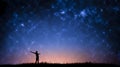 Night landscape with Milky Way. Silhouette of a standing young man with raised up arms on the mountain. Beautiful Universe. Travel Royalty Free Stock Photo