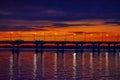 Night landscape of the new central bridge over the Dnieper river in Dnipro Ukraine. Urban panorama with orange sunset, lanterns Royalty Free Stock Photo