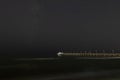 Night landscape. Small pleasure boat moored to a pier near the sea coast. Royalty Free Stock Photo