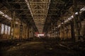 Night at large abandoned industrial hall with garbage. Voronezh excavator manufacturing factory