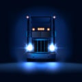 Night large classic big rig semi truck with headlights and dry van semi riding on the dark night background front view Royalty Free Stock Photo