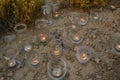 Night light candles burning in upcycled glass jars in desert