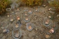 Night light candles burning in upcycled glass jars in desert