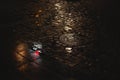 Night light reflection on wet cobblestone pavement after rain. Royalty Free Stock Photo