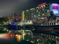 Night light on sea water and ship buildings windows in harbor in Tallinn old town