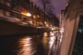 Night lighting reflections in Amsterdam channels from moving cruise boat. Blurred abstract photo as background. Royalty Free Stock Photo
