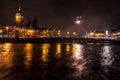 Night lighting reflections in Amsterdam channels from moving cruise boat. Blurred abstract photo as background.