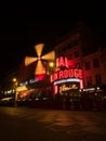 Night long exposure of Moulin Rouge concerts club entertainment cabaret Pigalle Montmartre Paris France Europe Royalty Free Stock Photo