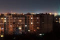 Night long exposure photo 9 and 10 floors high-rise buildings in orange colours. Big city life is here