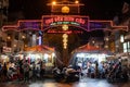 Night market in Asia. People walking or on a motorcycle. Buying clothes and food. No social distance before Covid-19. Ninh Kieu