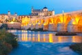 Night Mezquita and Roman bridge in Cordoba, Spain